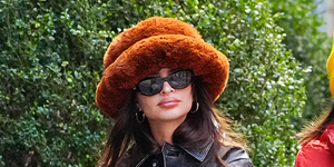 a woman wearing sunglasses and a hat