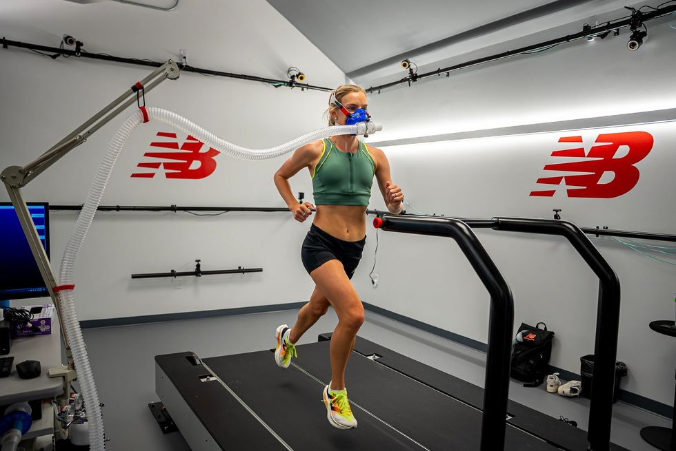 emily sisson running on a treadmill wearing an oxygen mask