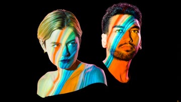 emma corrin and nabhaan rizwan in anna x seen against a plain background, with colourful stripes of light shining over their faces