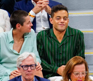 emma corrin and rami malek seated together at the us open september 2023