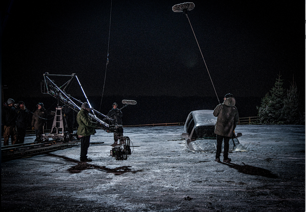 strictly embargoed until 0001 friday january 10 the emmerdale crew film at night as a car is seen on a frozen lake