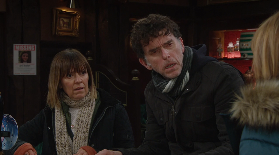 emmerdale characters marlon dingle and rhona goskirk reacting to some shocking news in the woolpack pub