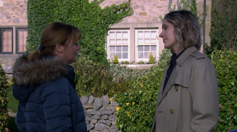 emmerdale, wendy and the reporter talk outside in the village