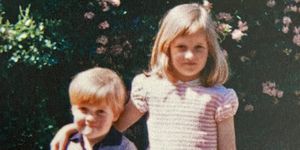 a young princess diana wearing a pink striped dress, her arm around her younger brother charles spencer