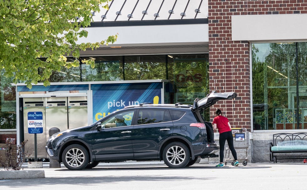 employee puts groceries in car