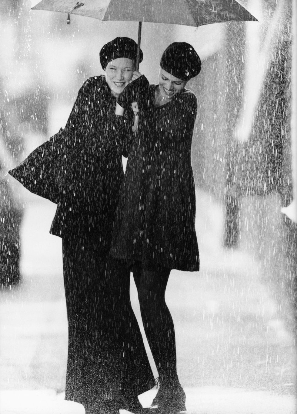 a man and woman standing under an umbrella