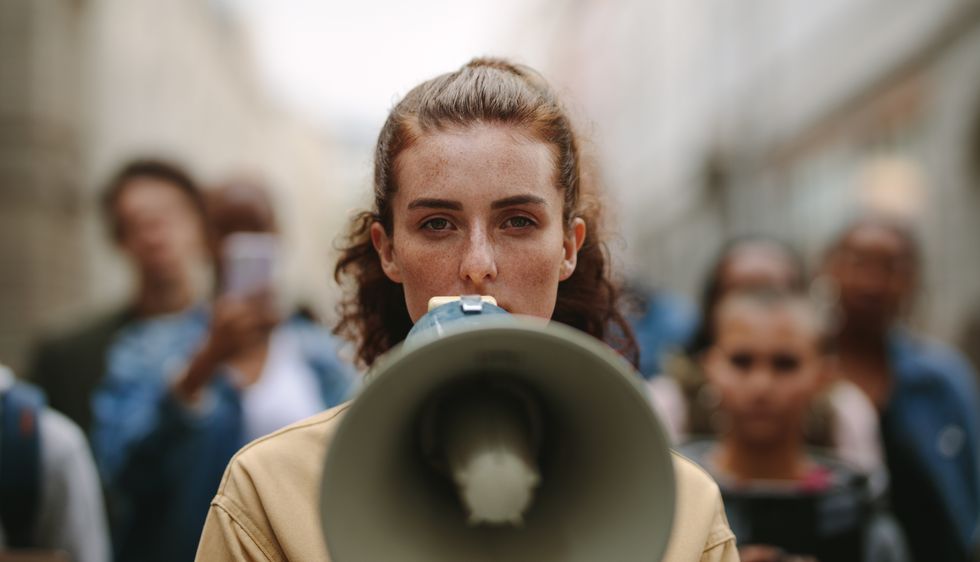 female activist protesting with megaphone