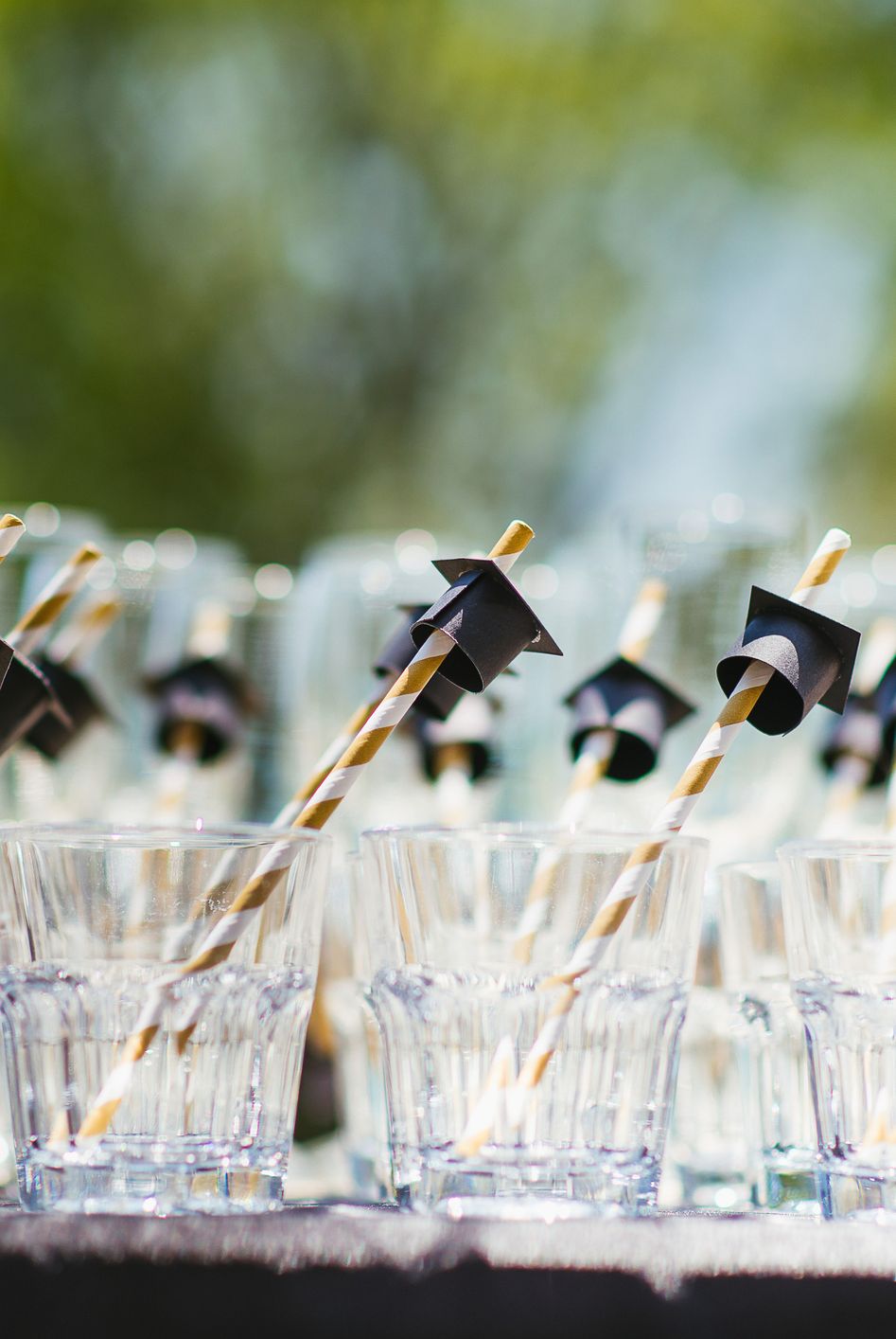 glass with grad cap straw
