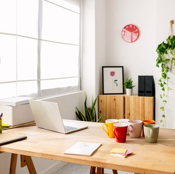 empty modern creative room studio of freelance or entrepreneur person with an online e commerce business. modern space with table, laptop and some products to delivery