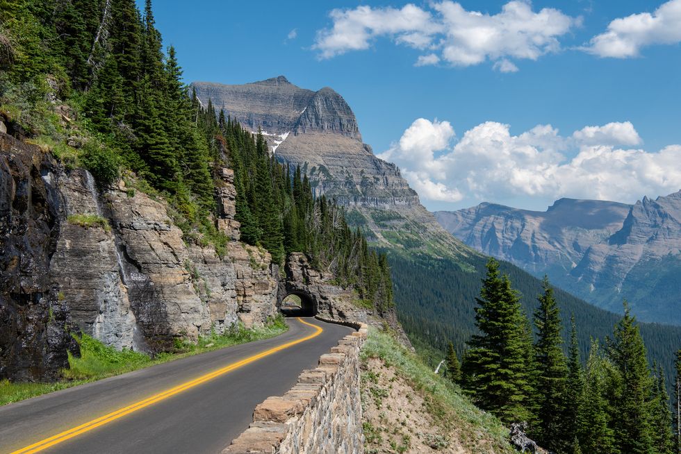 empty road along mountains against sky,glacier national park,montana,united states,usa