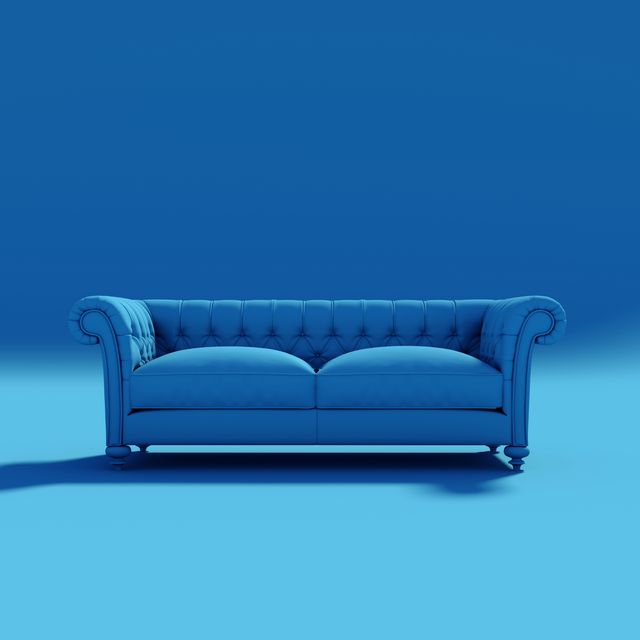 empty sofa against blue background