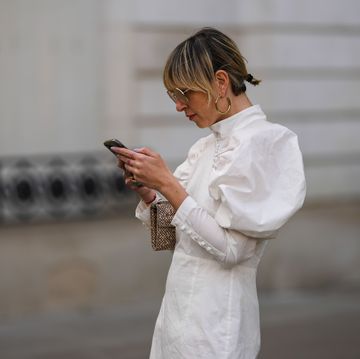 fashion photo session in paris may 2022 white dress woman with phone