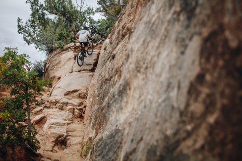 climbing up the snotch boulders on the enchilada bike trail in moab utah