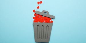 End of love and couple relationship. Discarded red hearts in trash