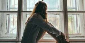 vrouw met endometriose kijkt door het raam