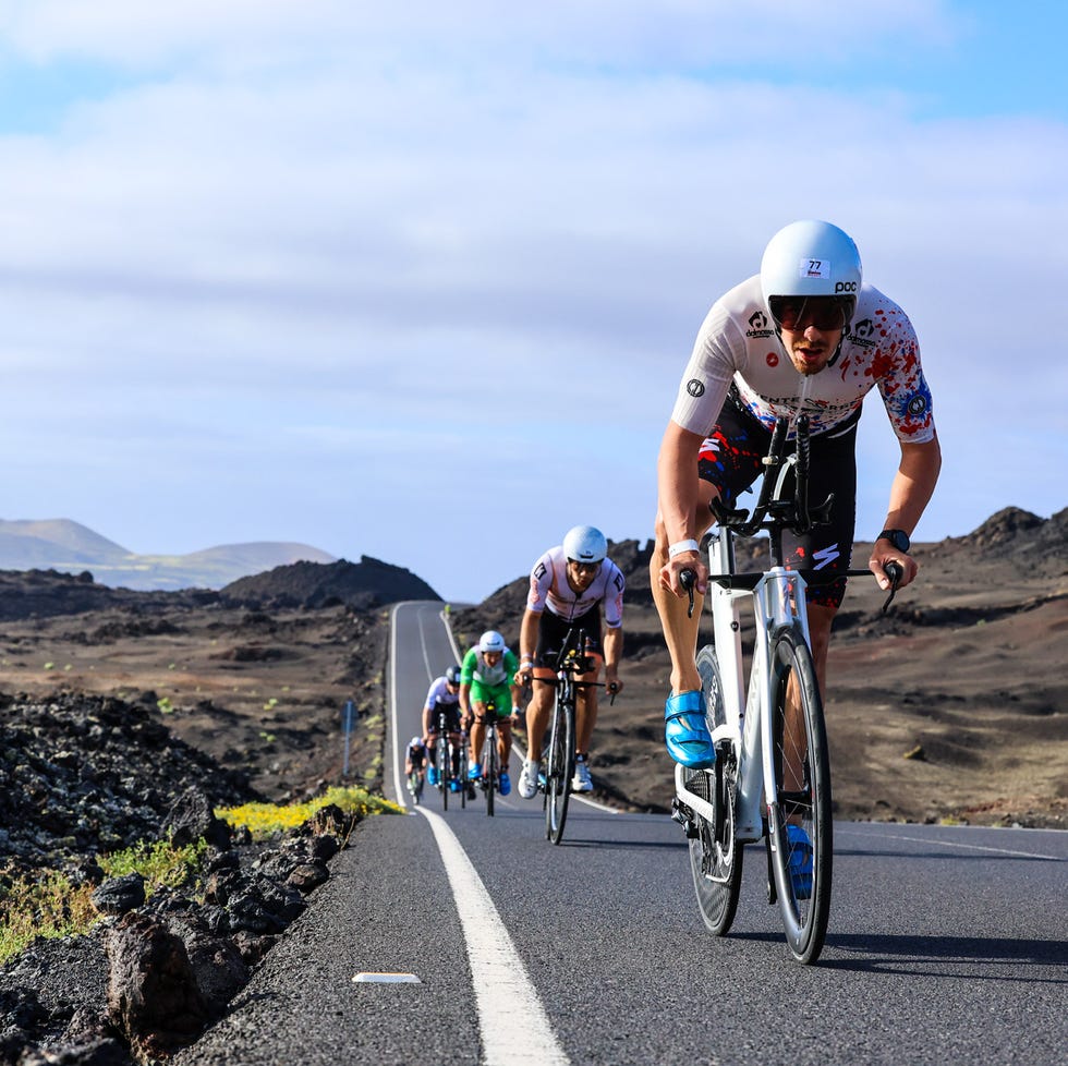 a group of people riding bikes on a road