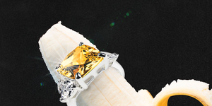 a yellow diamond engagement ring on a peeled banana