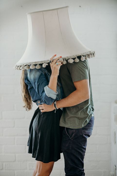 couple kissing under lampshade