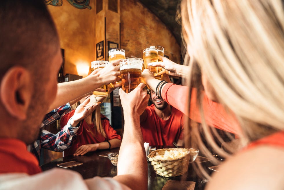 group of happy friends drinking beer at the brewery