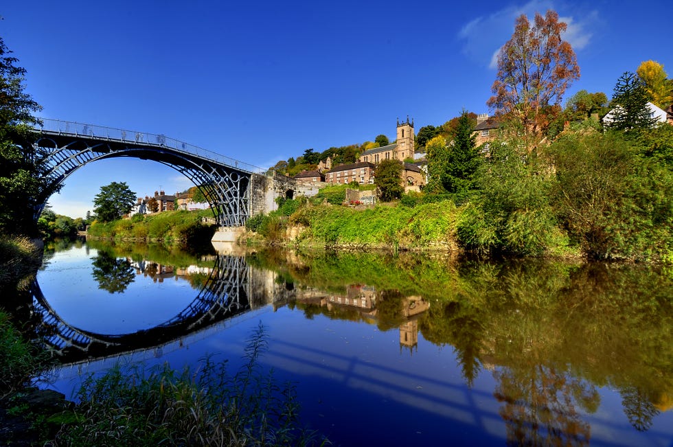 uk, england, shropshire, telford, symmetrical view of ironbridge and hill reflecting in water
