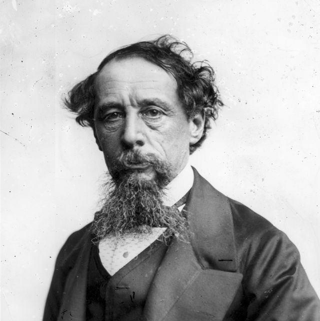 a black and white photograph of charles dickens wearing a suit and looking directly into the camera