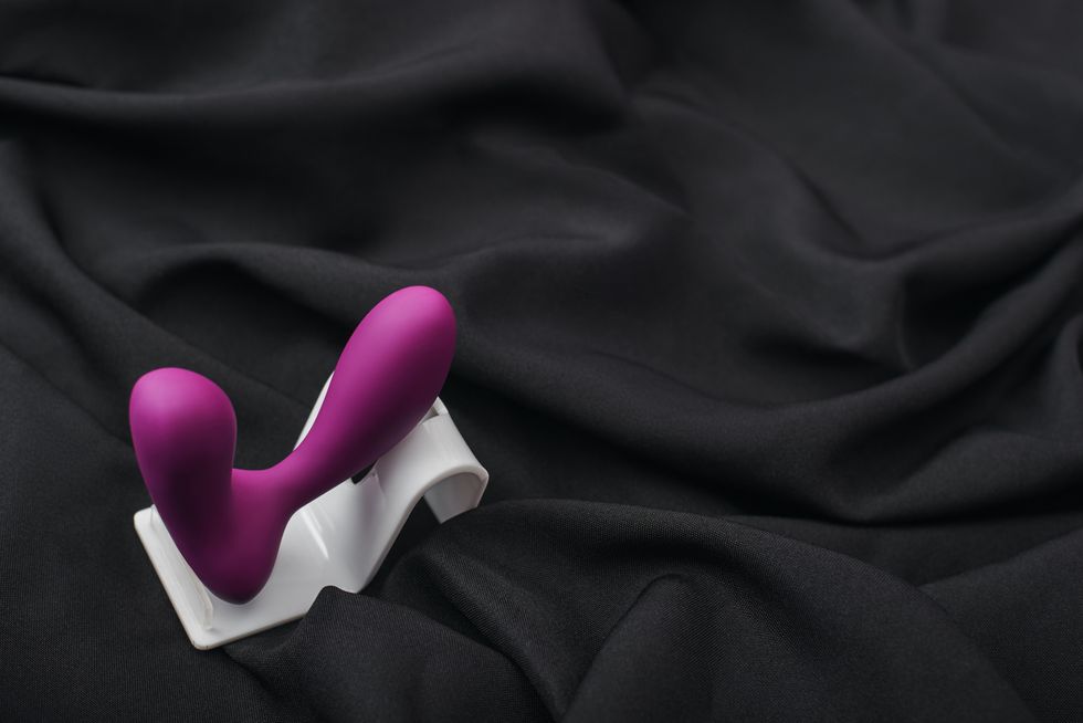 enhance your sex life close up of silicone prostate massager on a black silk fabric