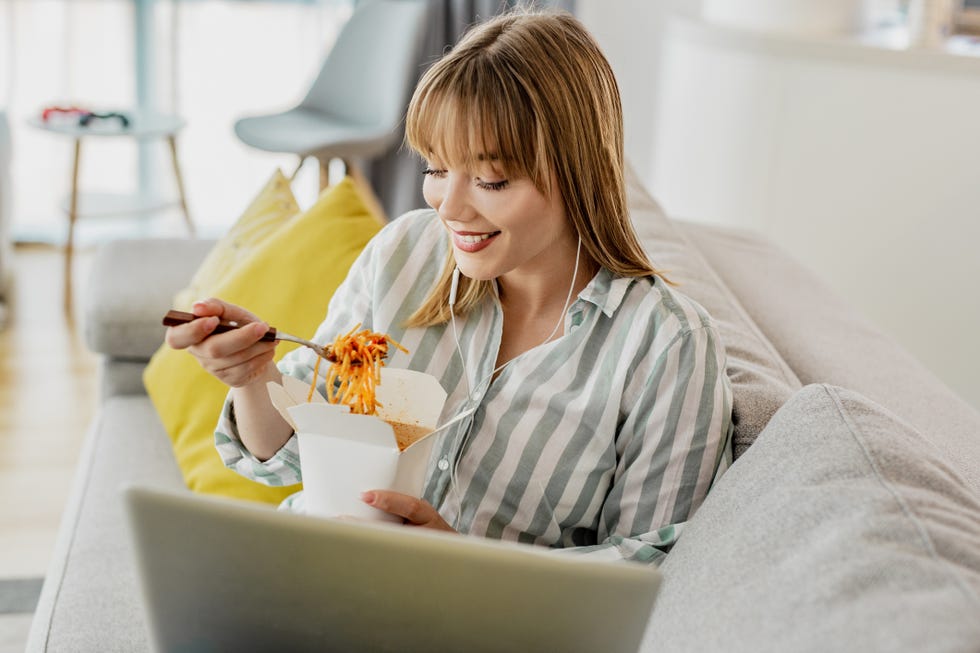 enjoying at home eating takeaway meal