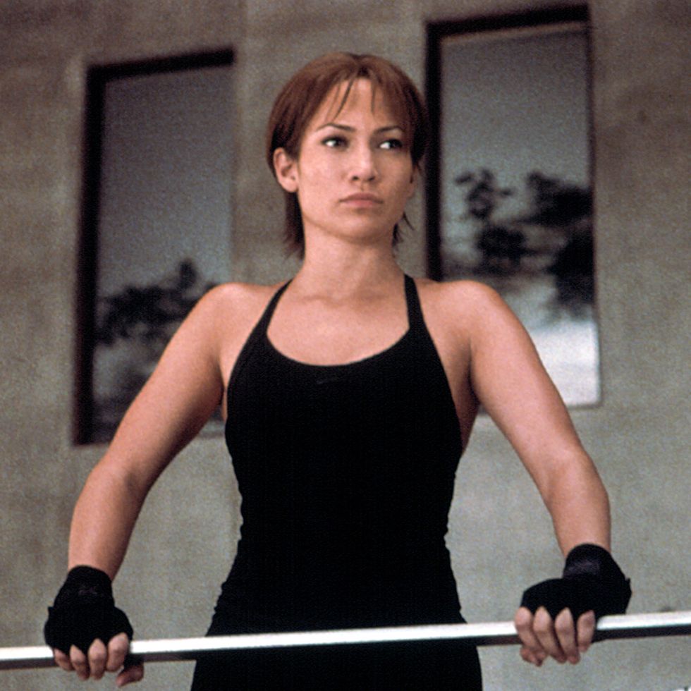 jlo in a black leotard holding a barbell