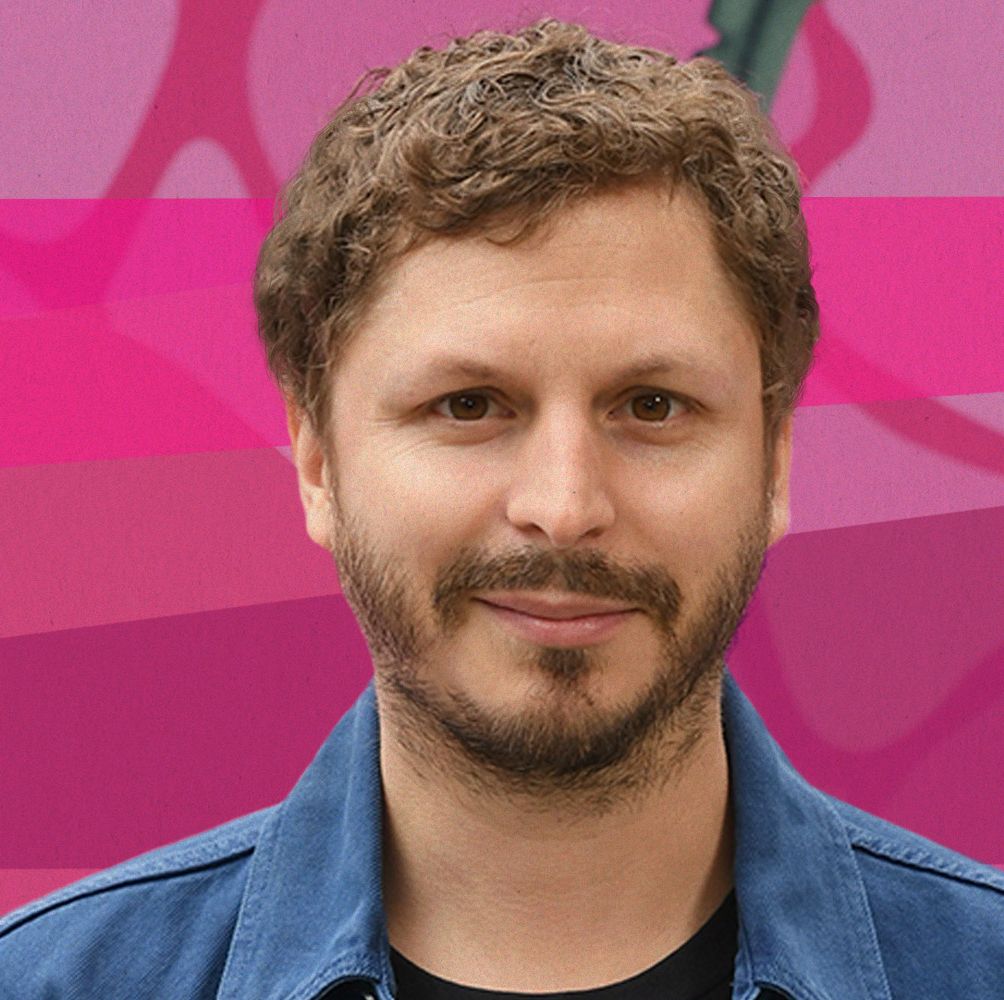 michael cera posing for cameras, in front of a pink backdrop
