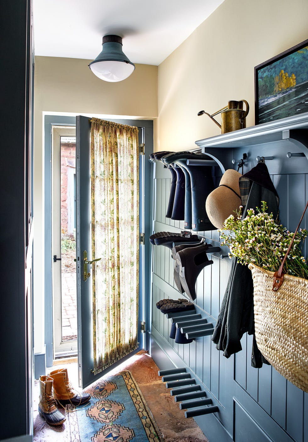 blue mudroom with boot pegs on the walls