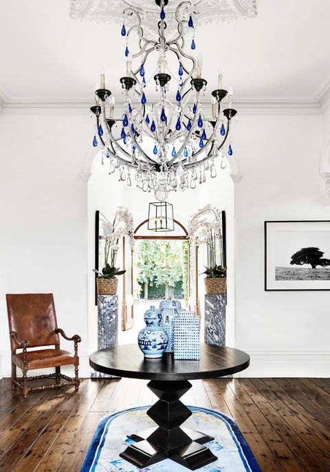 eclectic blue entryway with chandelier