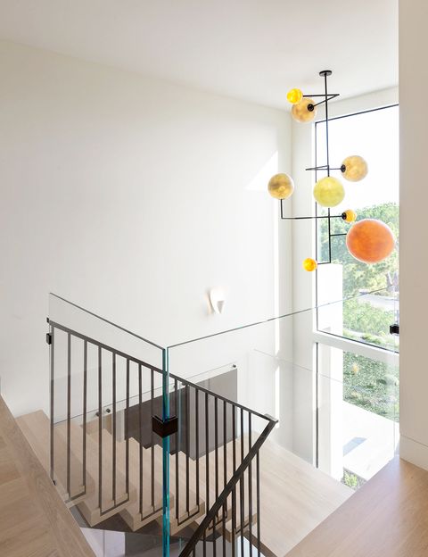 entryway stairwell with bold light fixture