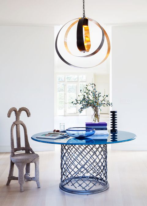 entryway with modern blue table, chair, and lamp