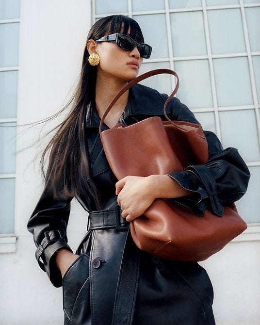 a woman wearing sunglasses and a leather jacket