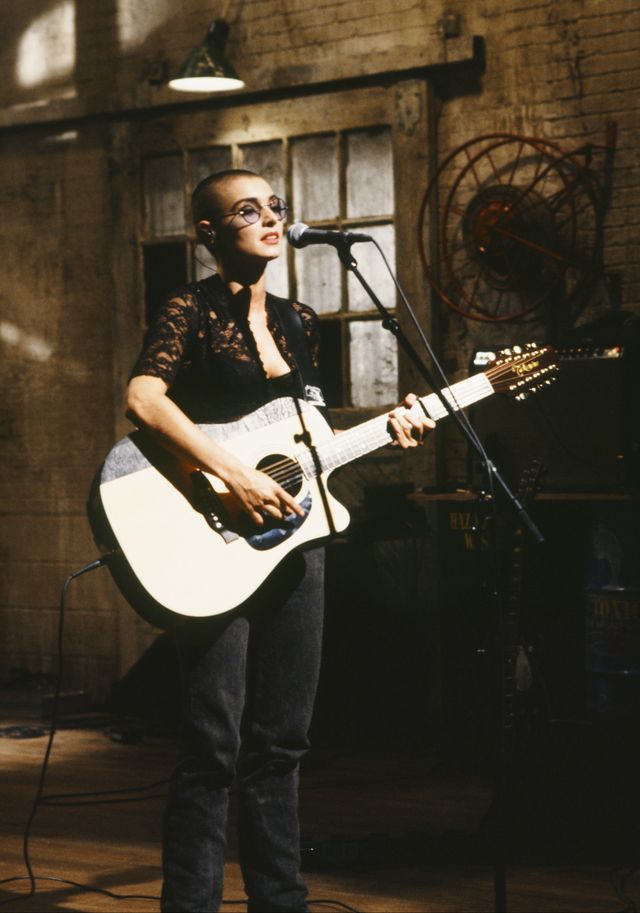sinead o connor playing a guitar during her performance on saturday night live