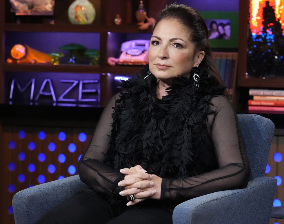 gloria estefan sitting in a guest chair with her hands folded across her lap