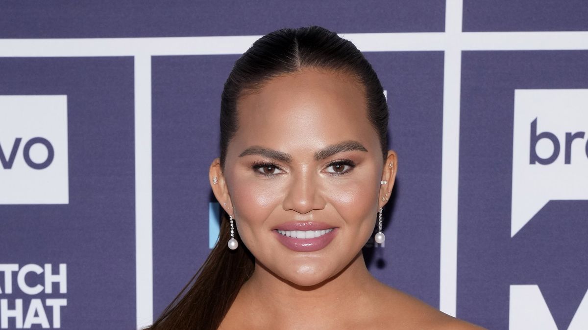 preview for Chrissy Teigen shows off hip-length 70's waves