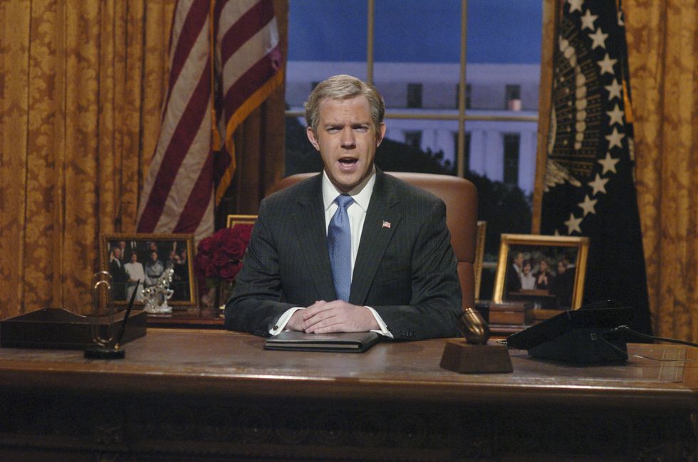 man acting as us president sitting behind a desk