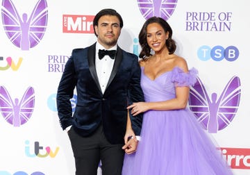 vicky pattison and ercan ramadan at the pride of britain awards 2023, ercan is wearing a black suit with bow tie, while vicky is wearing a long purple dress with frilly arms