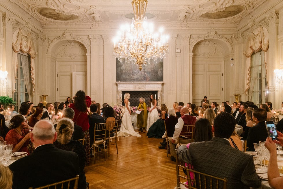 ceremony taking place in an elegant ballroom setting