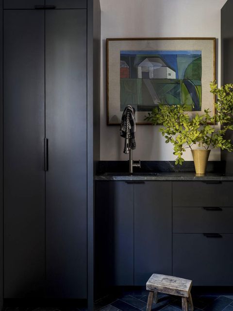 mudroom with dark cabinetry, sink