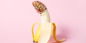 erotic fruit , banana covered with chocolate and colourful sprinkles