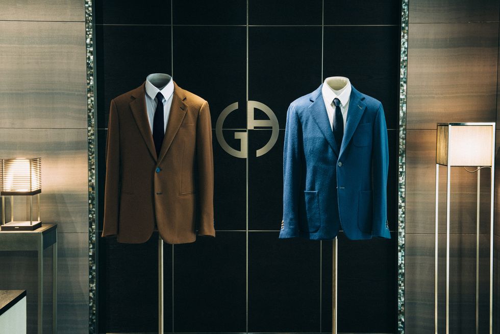 Suit, Clothing, Formal wear, Clothes hanger, Room, Display window, Outerwear, Display case, Tie, Wardrobe, 