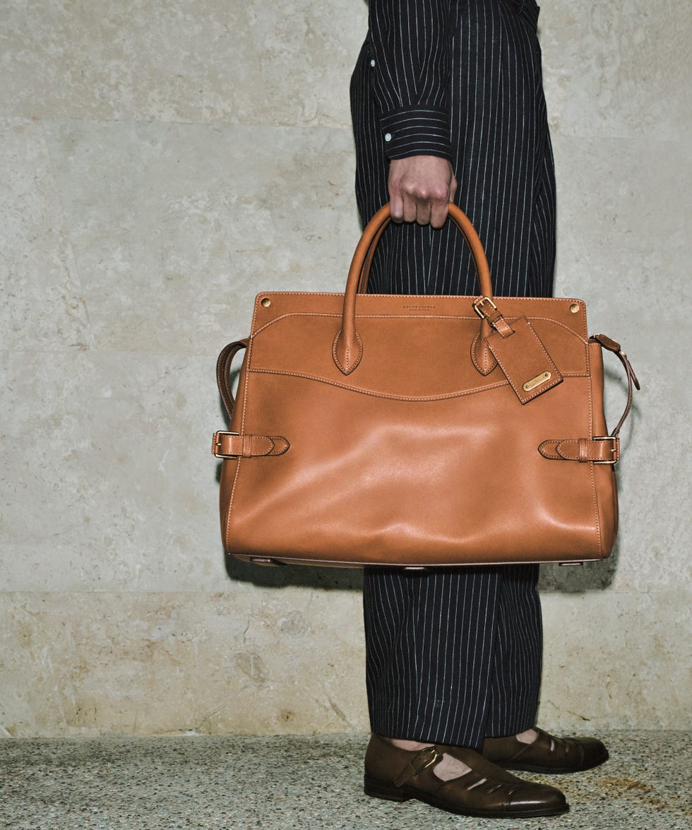 a person holding a brown bag