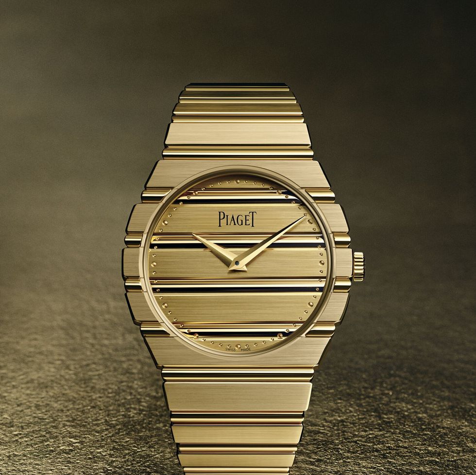 a gold watch with a black face