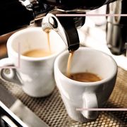 espresso machine filling two small white mugs