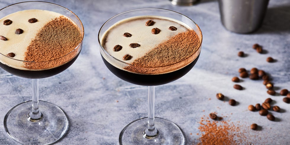 espresso martini in a coupe glass topped with espresso powder and coffee beans