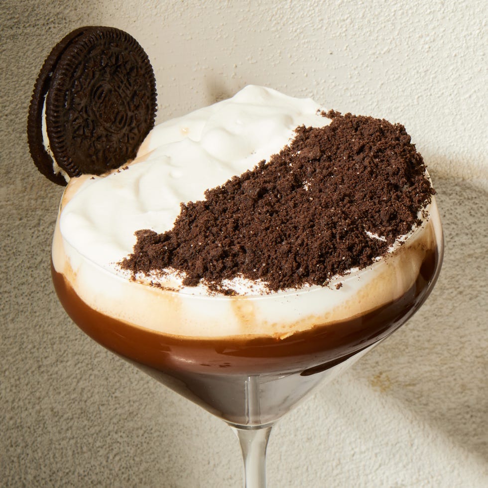 espresso mocha crunch mocktail in a martini glass with a whipped cream and chocolate topping and oreo garnish