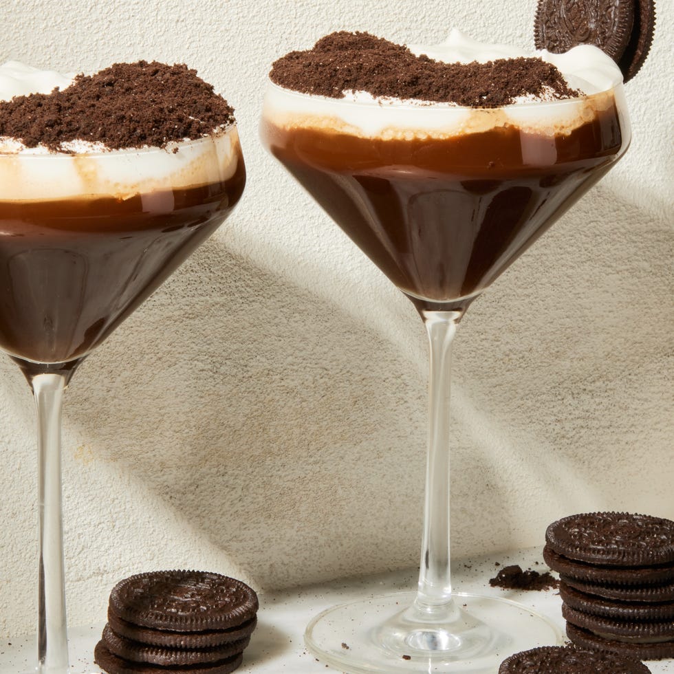 espresso mocha crunch mocktail in a martini glass with a whipped cream and chocolate topping and oreo garnish