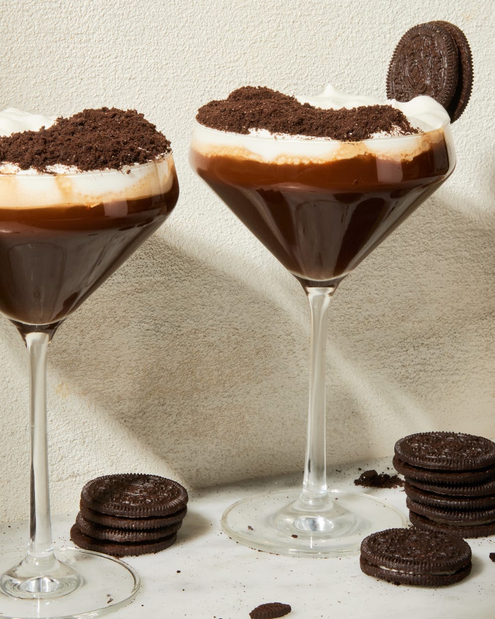 espresso mocha crunch mocktail in a martini glass with a whipped cream and chocolate topping and oreo garnish